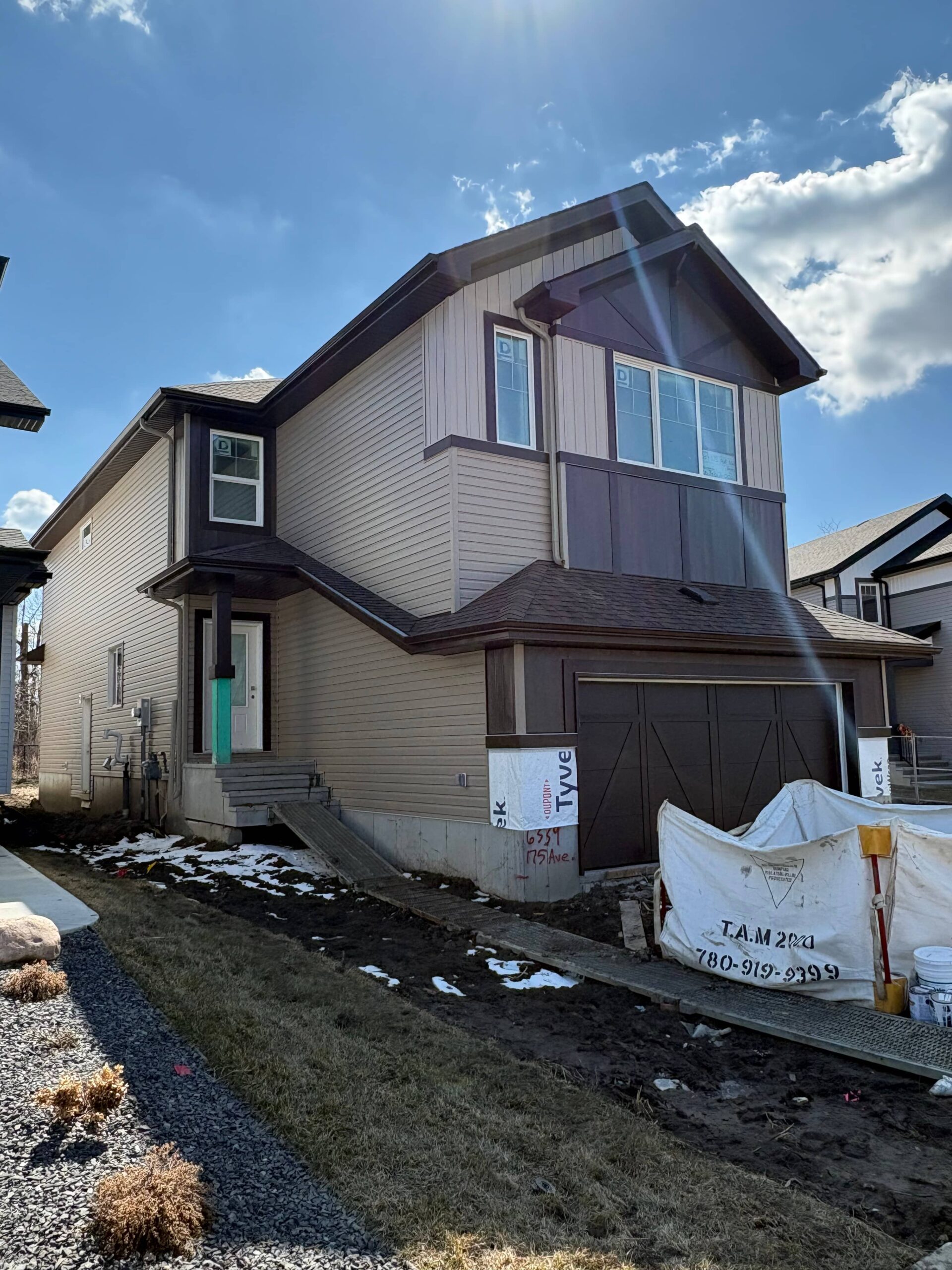 A houses showcasing siding installation and custom soffit, fascia finishing and Strong Finishes for Garages, Exterior Siding