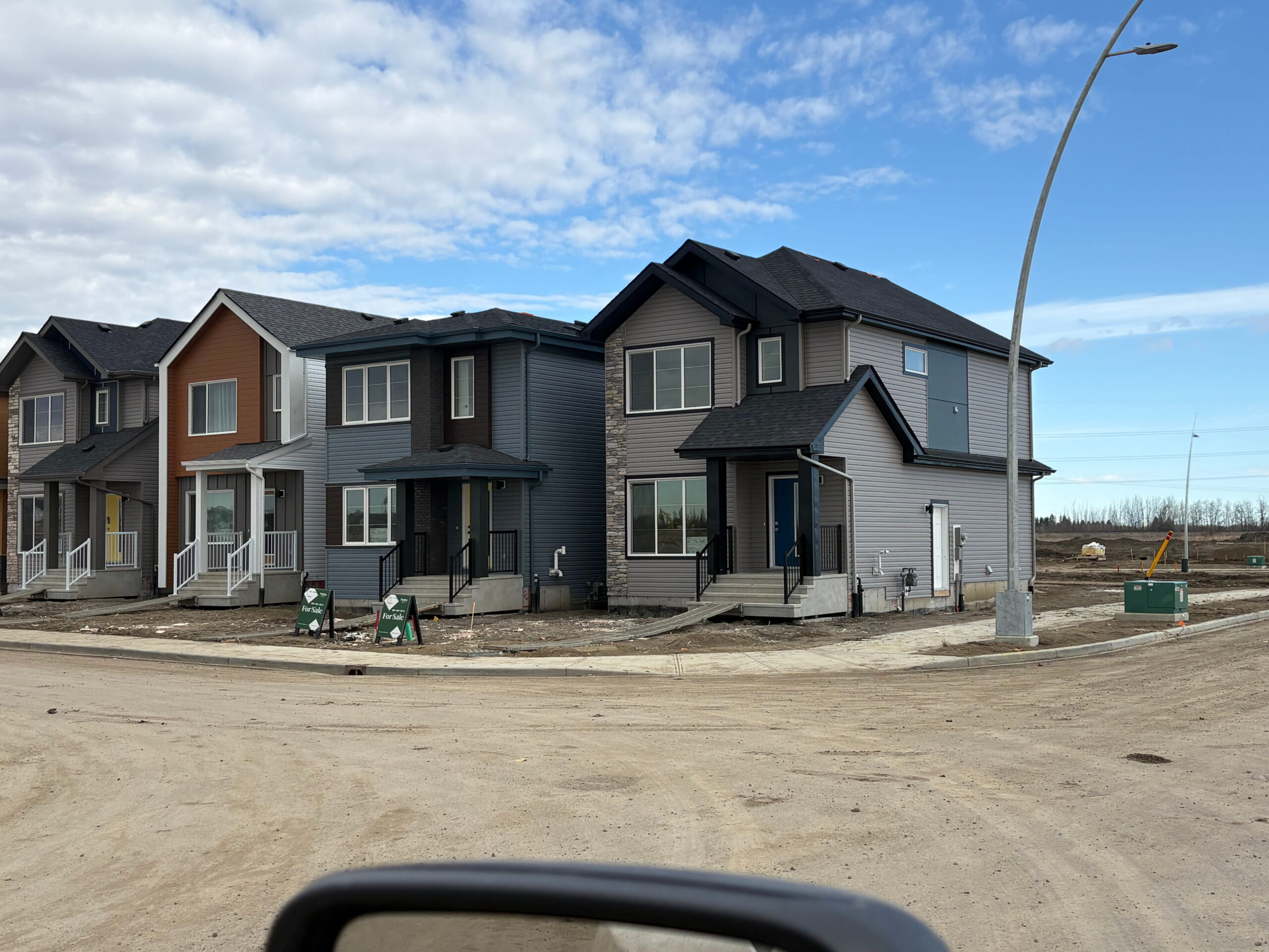 A houses showcasing siding installation and custom soffit, fascia finishing and Strong Finishes for Garages, Exterior Siding