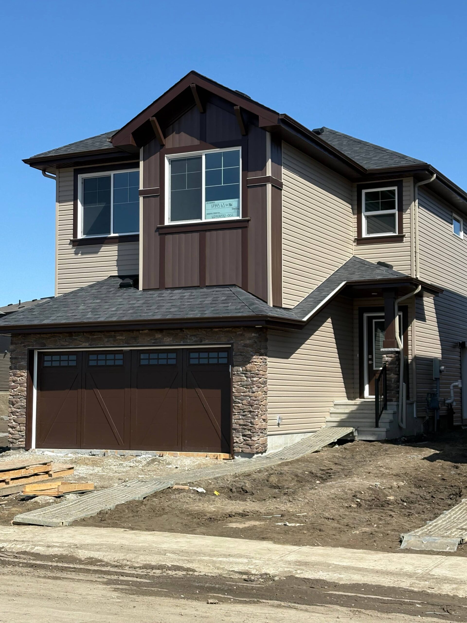 A houses showcasing siding installation and custom soffit, fascia finishing and Strong Finishes for Garages, Exterior Siding